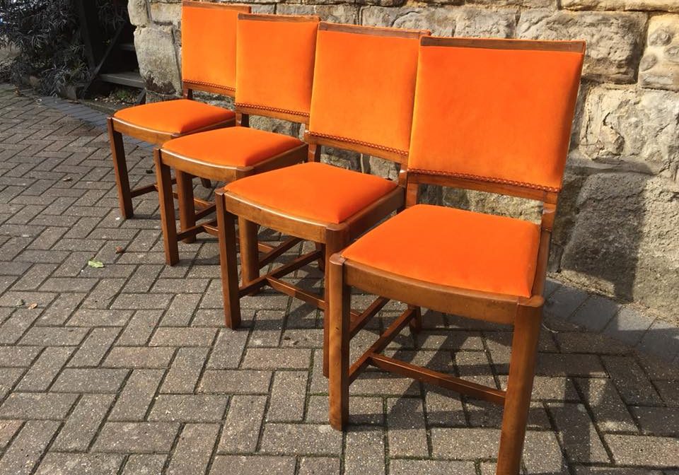 Set of orange dining chairs